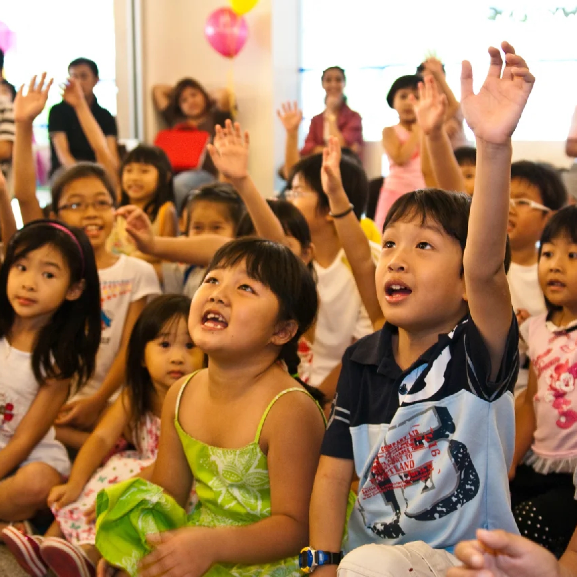 Excited children watching a birthday show